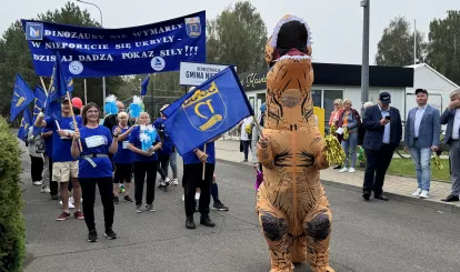 Olimpiada Seniorów Nieporęt 2026 - na zdjęciu reprezentacja gminy Nieporęt z maskotką - dinozaurem